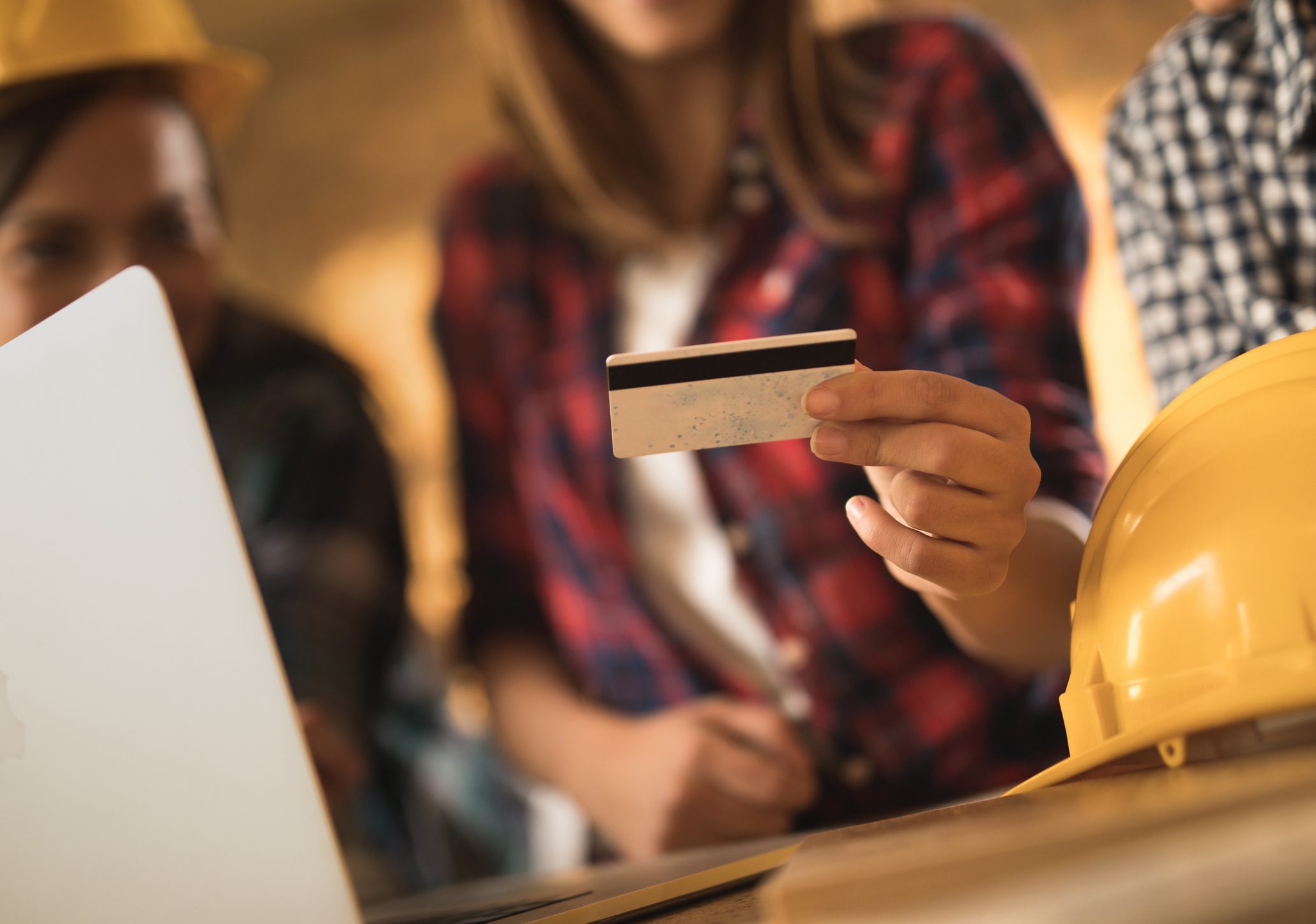 Person holding a credit card during a shopping transaction.